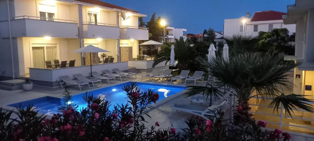 Luxury Apartments Cuba Novalja — pool and terrace in the evening