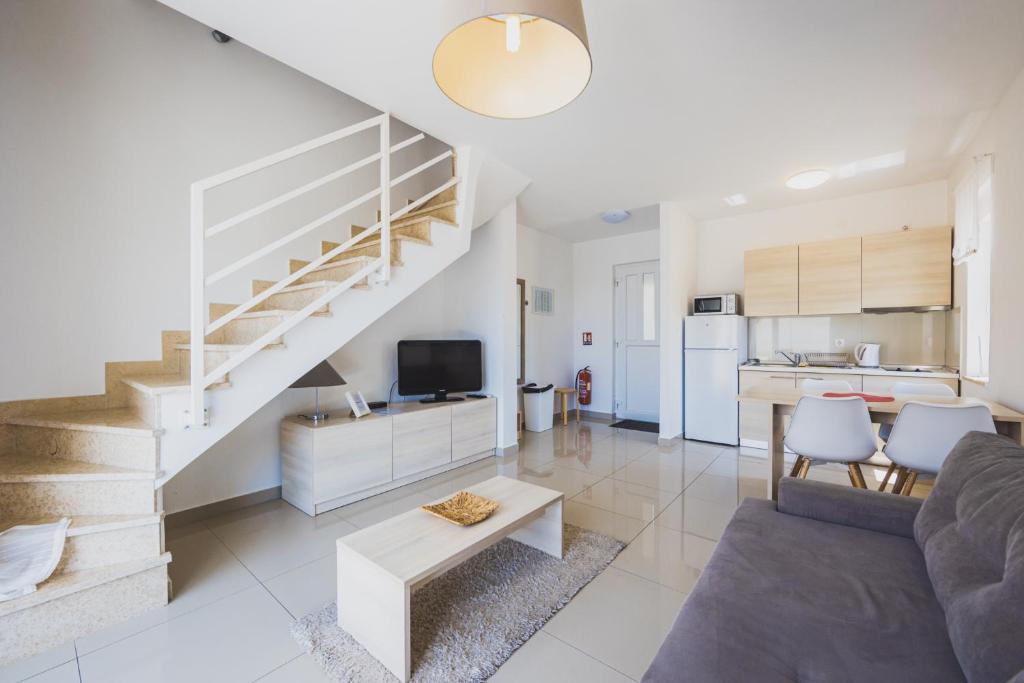 Open-plan living area with staircase and kitchen